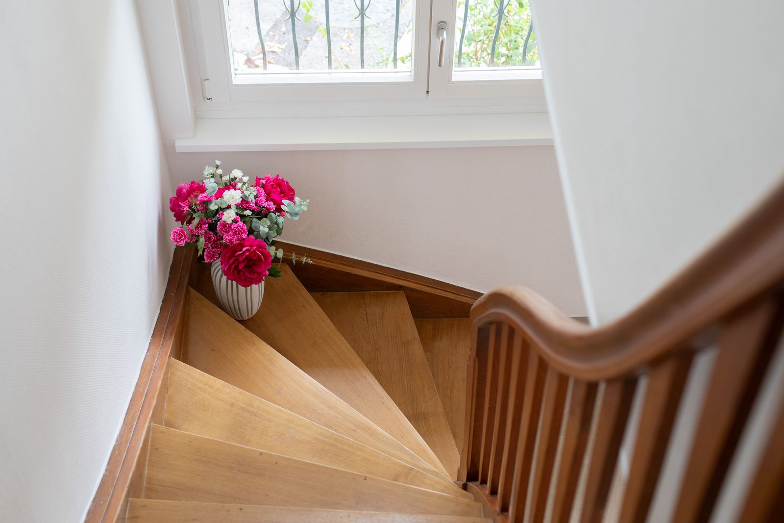 L’escalier en bois et un bouquet sur le palier